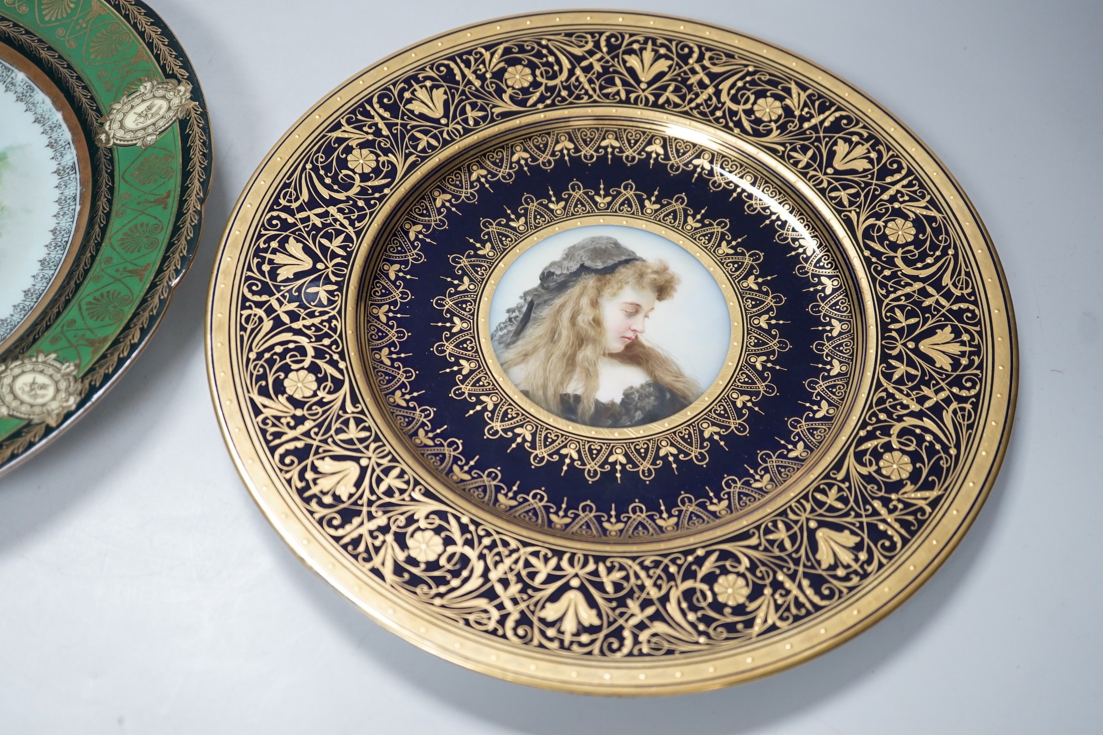 A Vienna style painted portrait plate, and another Vienna style plate both signed, largest 25cm diameter